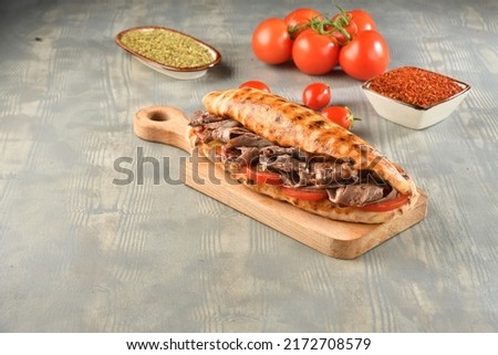 
Doner, marinated in Turkish meat, cooked on high heat, between bread (Turkish Name: ekmek arasi doner, doner, Turk kebabi)