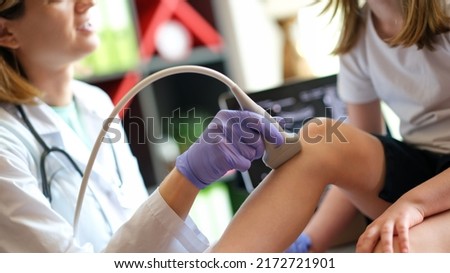 Patient child girl with orthopedic doctor medical ultrasound of knee. Diseases of skeletal system, diseases of joints in children concept Royalty-Free Stock Photo #2172721901