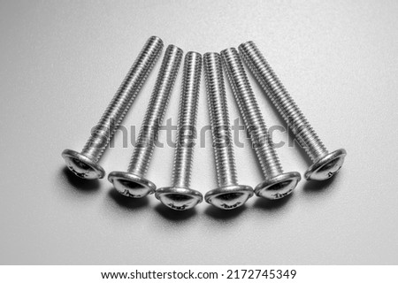 Set of six screws on a white background. Macro photo.
Background picture. Black and white.