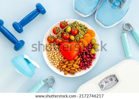 Food for heart health with sports fitness equipment. Healthy nutrition eating Royalty-Free Stock Photo #2172746217