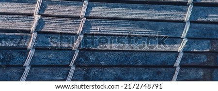 BANNER Old woven bamboo rug, rough texture dirty, fragment banner. Diagonal horizontal vertical lines, contrast shadow. Copy space for text. Abstract background. Light dark blue grey tones more stock