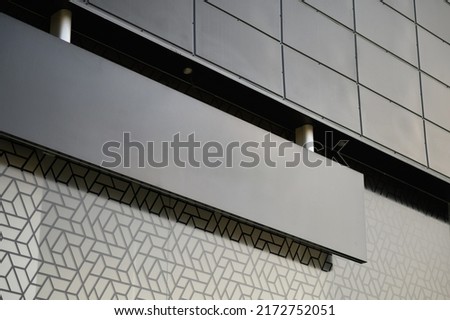 Blank black signboard mock up. Empty signage template in modern bright building interior.