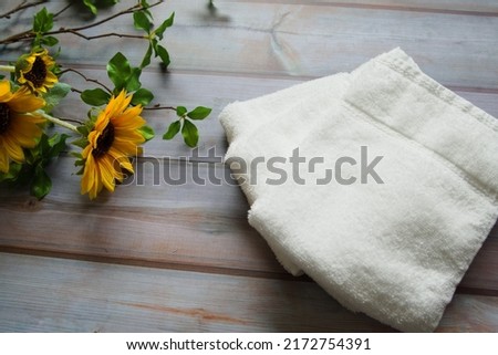 Pictures of white towels and sunflowers