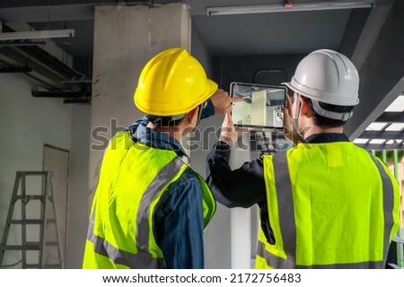 Engineer, architect and construction supervisor Use tablet to record information while inspecting construction work. Construction supervisor, architect or engineer inspect construction inside building Royalty-Free Stock Photo #2172756483