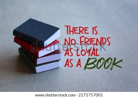 Close up image of books and quotes " There is no friends as loyal as a book". 