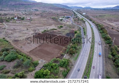 erial footage of the Mumbai-Pune Expressway near Pune India. The Expressway is officially called the Yashvantrao Chavan Expressway. Royalty-Free Stock Photo #2172757241