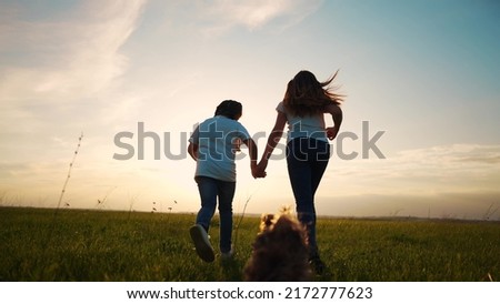 children and dog run in the park. happy family kid dream concept. two little girls sisters holding hands running summer on the grass in the park a shaggy lifestyle dog runs nearby. children run