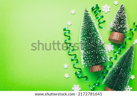 Flat lay composition with christmas trees on color background. Top view with copy space.