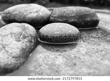 Smooth stones in shallow water                             