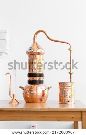 Distillation of lavender essential oil. Copper alambic in a Scandinavian interior. Royalty-Free Stock Photo #2172808987