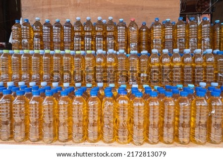 selectively focus on plastic bottles containing bulk cooking oil, in Indonesian it is called minyak goreng curah