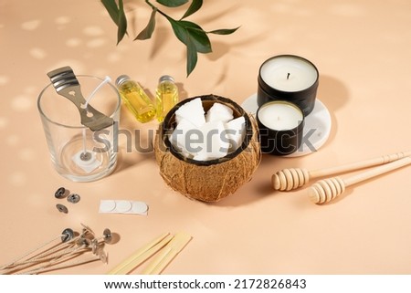 Set for homemade natural eco-friendly coconut wax candles, wick, perfume, aroma oil. Candle making utensils.Trendy diy candles to health on beige background.Copy space.Cruelty-free vegan product Royalty-Free Stock Photo #2172826843