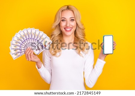 Photo of cute pretty lady dressed white shirt holding cash fan device empty space isolated yellow color background