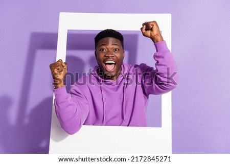Photo of satisfied excited person raise fists celebrate achieve success isolated on purple color background