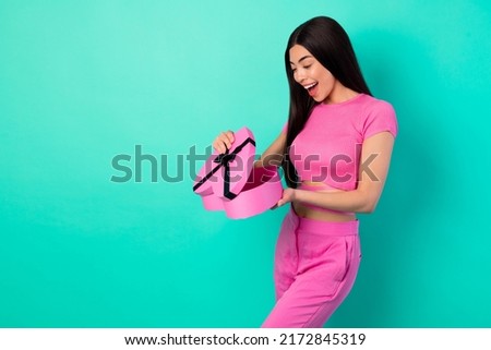 Photo of sweet girlish lady open heart shape packages enjoy 14 february occasion isolated cyan color background