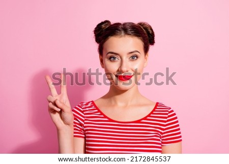 Portrait of gorgeous satisfied person hand fingers demonstrate v-sign isolated on pink color background