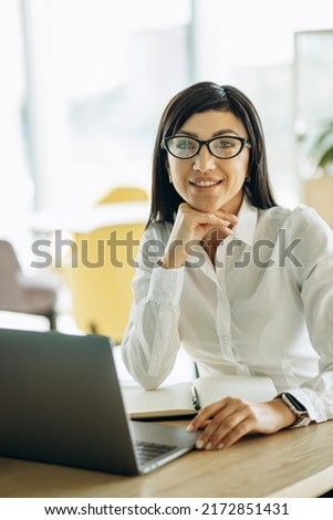 Young business woman working in office on computer