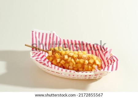 Delicious Crunchy Korean Style Chunky Potato Corn Dogs with Batter and Fried Potatoes. Isolated on Cream Background with Copy Space for Text Royalty-Free Stock Photo #2172855567