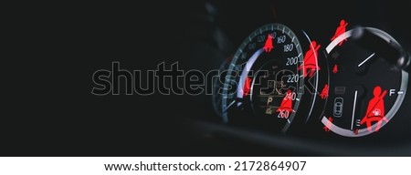 Seat belt signal on car dashboard with a seat belt illuminated icon double exposure on panoramic background