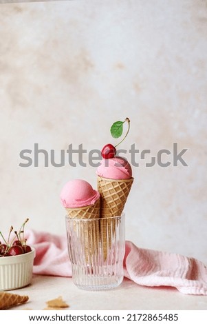 Creamy vegan cherries ice cream in the horn in a glass, styling cherry on top. Summer seasonal cold sweet healthy vegan dessert. High quality photo Royalty-Free Stock Photo #2172865485