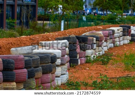 Used tires for fencing on racing track Royalty-Free Stock Photo #2172874559