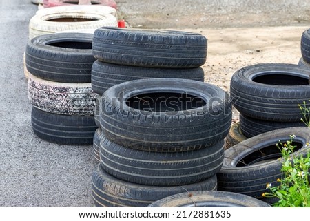 Used tires for fencing on racing track Royalty-Free Stock Photo #2172881635