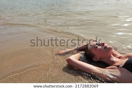young woman lying on the beach