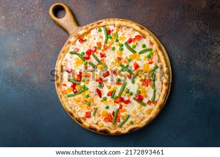 Pizza with vegetables vegetarian on the board top view on blue concrete table