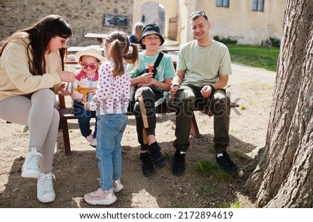 Family sitting at table in Veveri castle, Czech Republic.