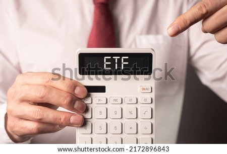 ETF analysis concept. Word on calculator. High quality photo