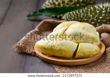 Long Laplae Durian on  wood plate,It is the most expensive and most delicious of all durians. Rare durian in Thailand Royalty-Free Stock Photo #2172897275