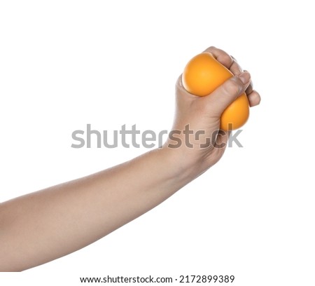 Woman squeezing antistress ball on white background, closeup Royalty-Free Stock Photo #2172899389