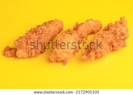Chicken strips, chicken strips on yellow background, bright background Royalty-Free Stock Photo #2172905105