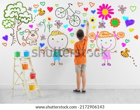 Cute child boy drawing of colorful dye many different picture on white wall