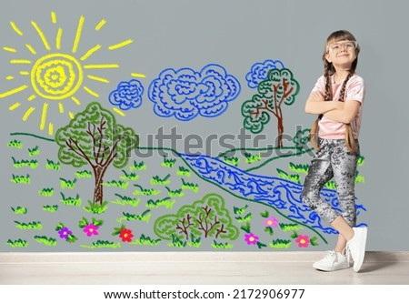 Portrait of cute child girl near colorful dyed gray wall
