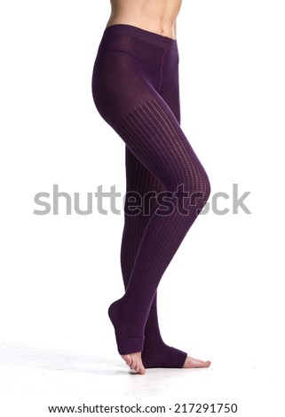 female legs in leggins purple  in front of white background
