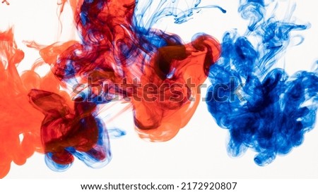 Blue and red ink in water. Abstract background.
