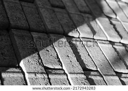 Black and white construction wall texture closeup with shadows and lines. Abstract urban photography. Rough and uneven surface design. 