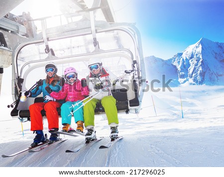 Ski, skiing - skiers on ski lift Royalty-Free Stock Photo #217296025