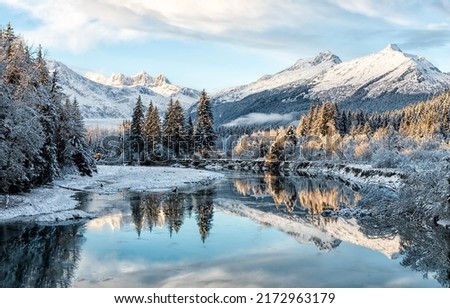 Mountain river valley in snowy winter. River valley in snowy mountains. Mountain river valley in snow. Winter snow river in mountains Royalty-Free Stock Photo #2172963179