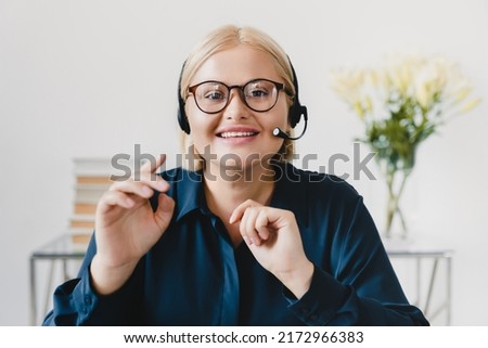 Online tutoring, e-learning concept. Tutor teacher student in headset headphones having video lesson videocall conversation online, looking at camera.
