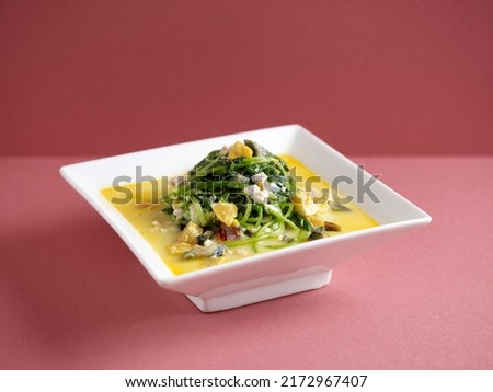 Poached Chinese Spinach with Egg Trio and Minced Pork with chopsticks served in a dish isolated on mat side view on grey background
