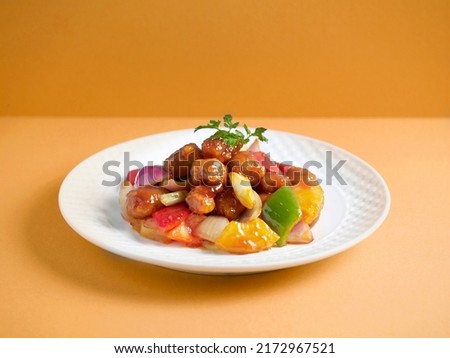 Sweet and Sour Pork with chopsticks served in a dish isolated on mat side view on grey background Royalty-Free Stock Photo #2172967521