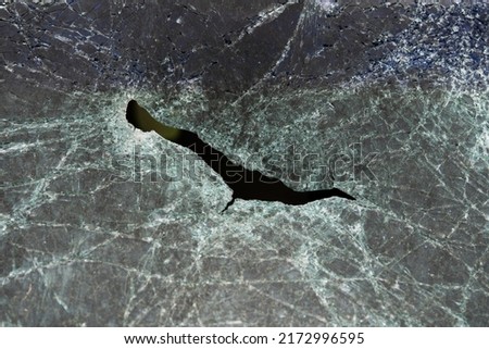 Abstract image of broken glass texture, background. Close-up of a broken car windshield. Broken and damaged car.
