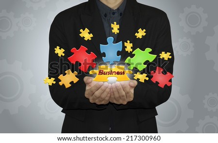 Business man with  jigsaw puzzle piece.