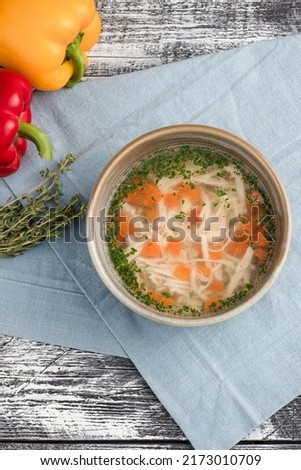 chicken soup, chicken soup on a white wooden background, top view