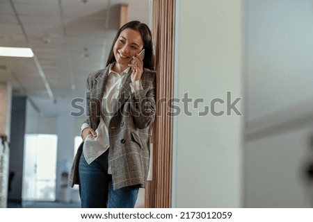 Asian business woman talking phone with client and smile. High quality photo