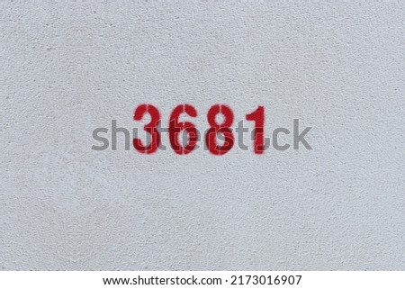 Red Number 3681 on the white wall. Spray paint.
