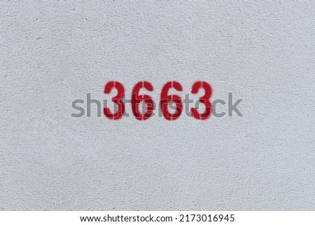 Red Number 3663 on the white wall. Spray paint.

