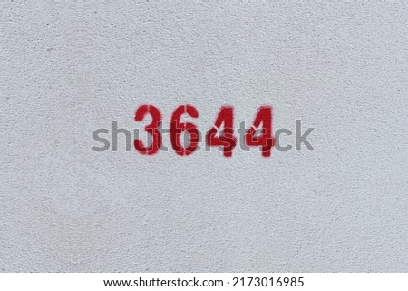 Red Number 3644 on the white wall. Spray paint.
